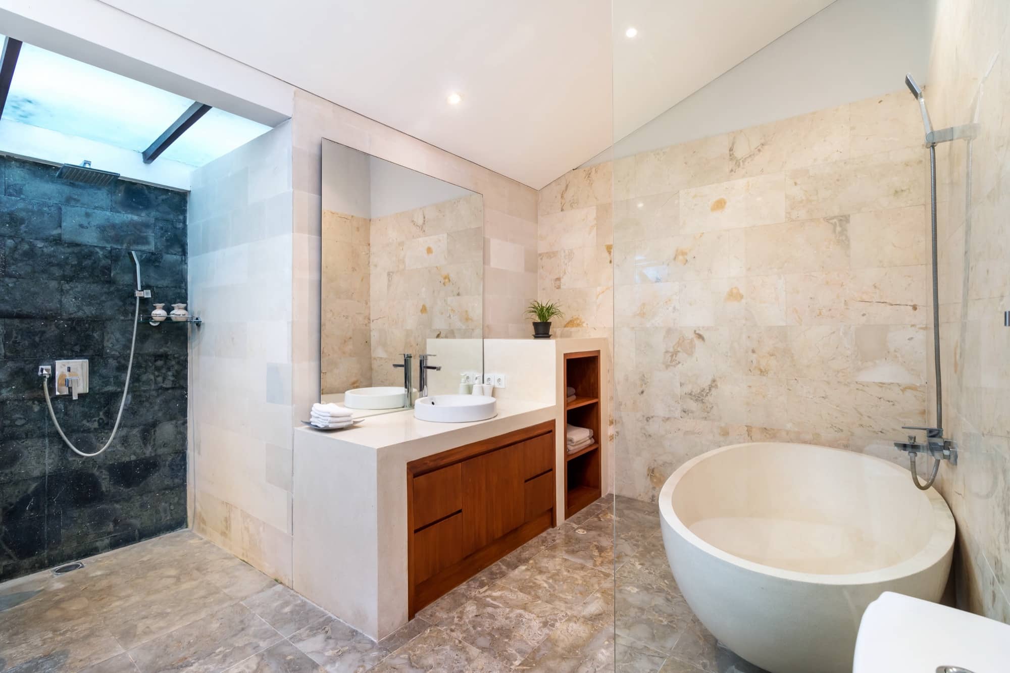 Villa Blue Bali — ensuite bathroom with deep stone soaking tub and rain shower