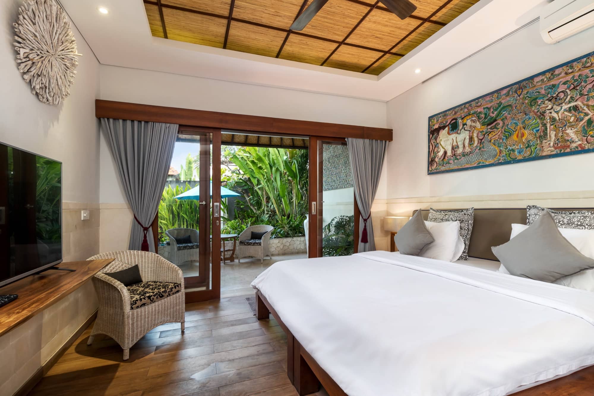 Villa Blue Bali — Bedroom 1, king bed with mural artwork, opening to a private terrace