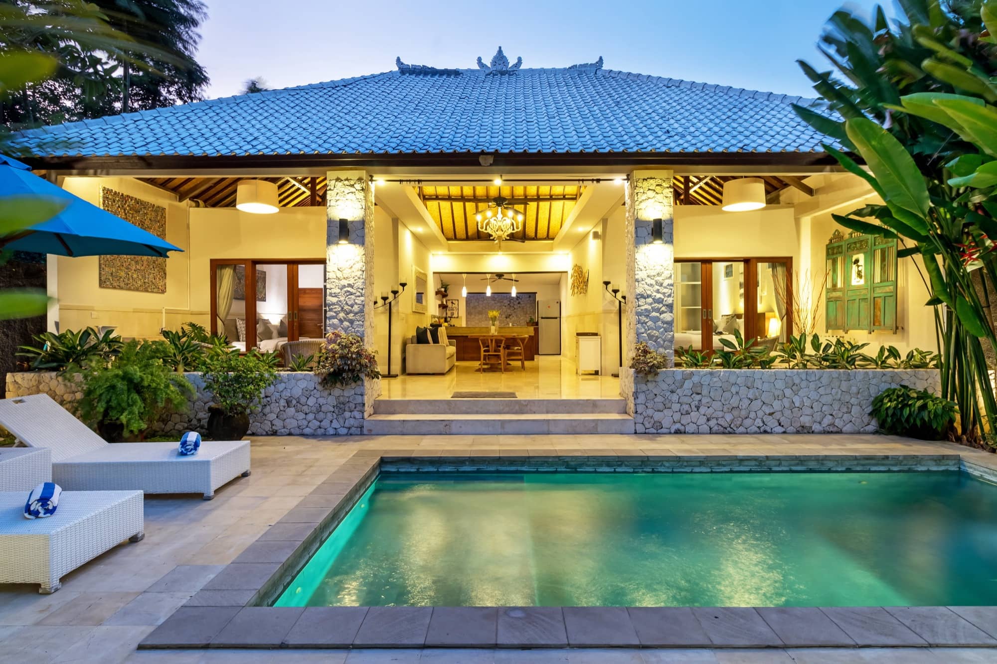 Villa Blue Bali — private pool lit at dusk with open-plan living pavilion behind