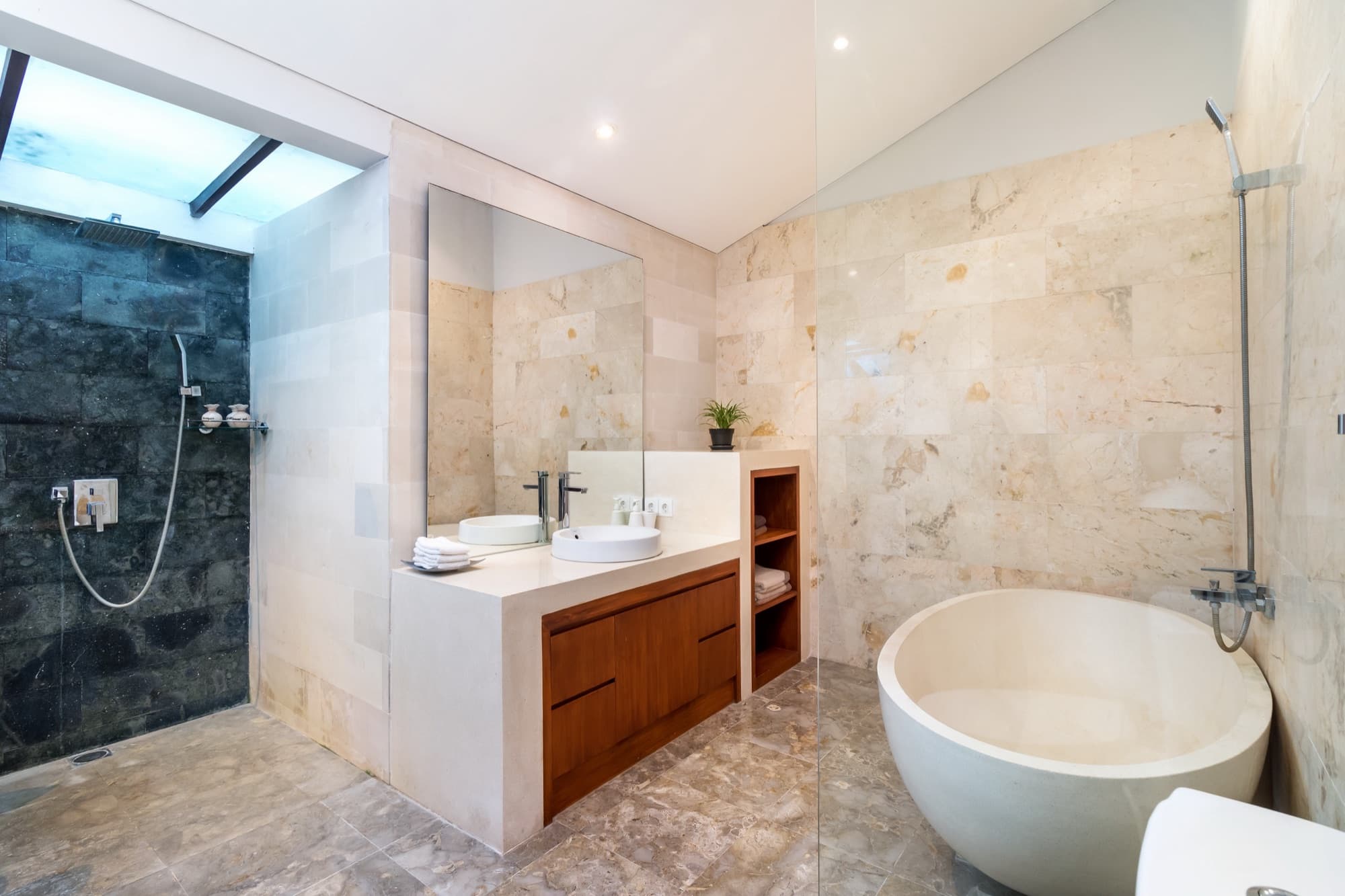 Villa Blue Bali — ensuite bathroom with deep stone soaking tub and rain shower