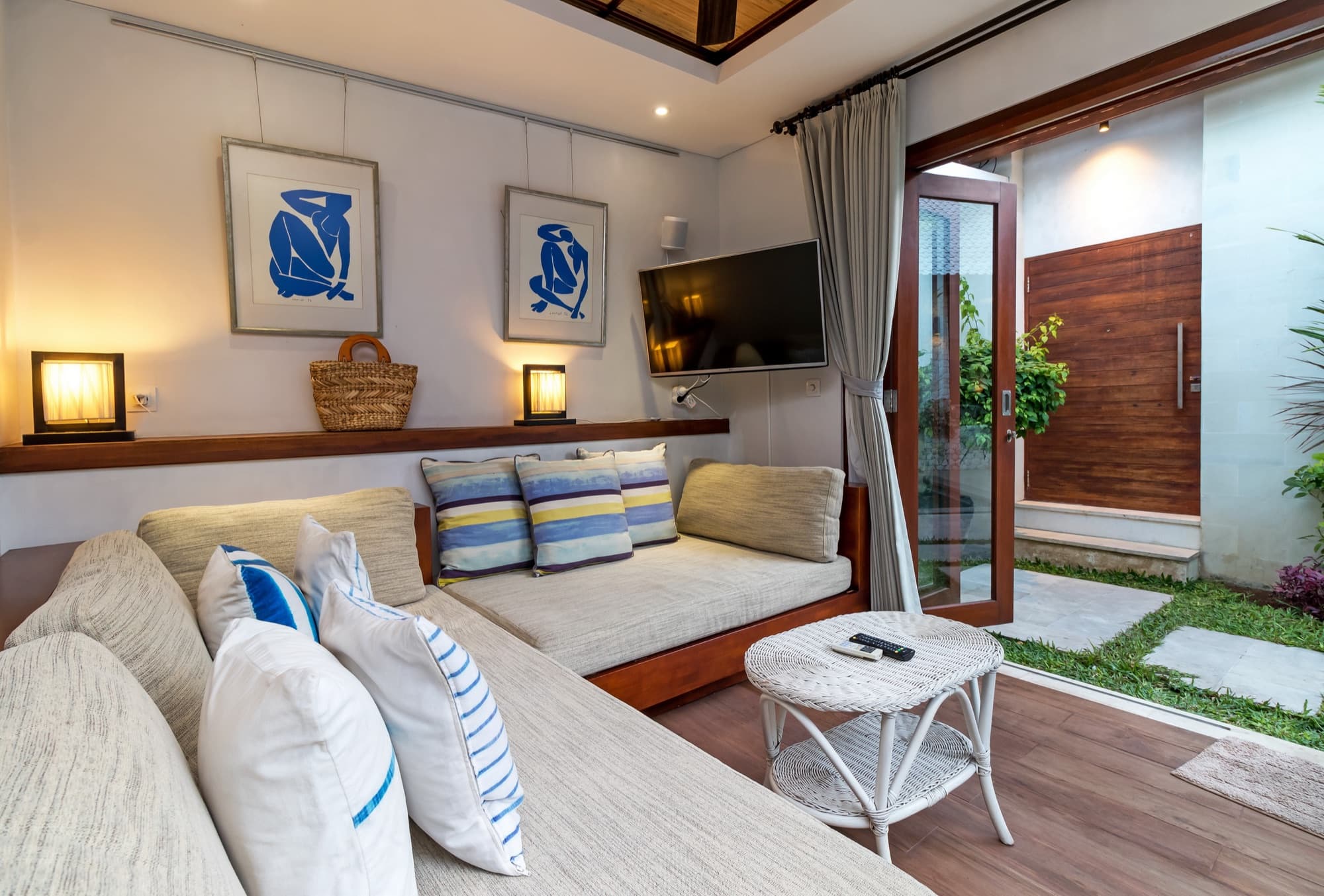 Villa Blue Bali — Bedroom 3 / media lounge with built-in couch and TV, blue Matisse prints