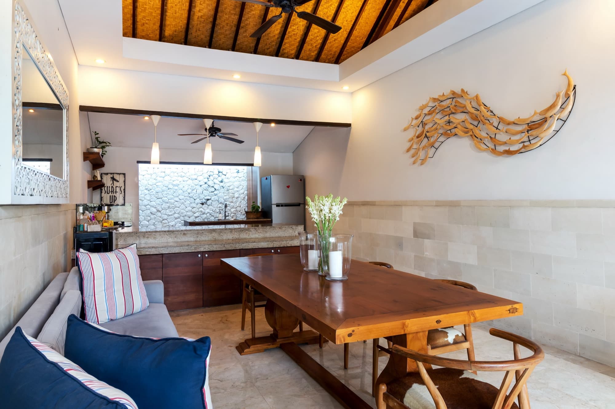 Villa Blue Bali — open-air dining room with long timber table and Balinese pitched ceiling