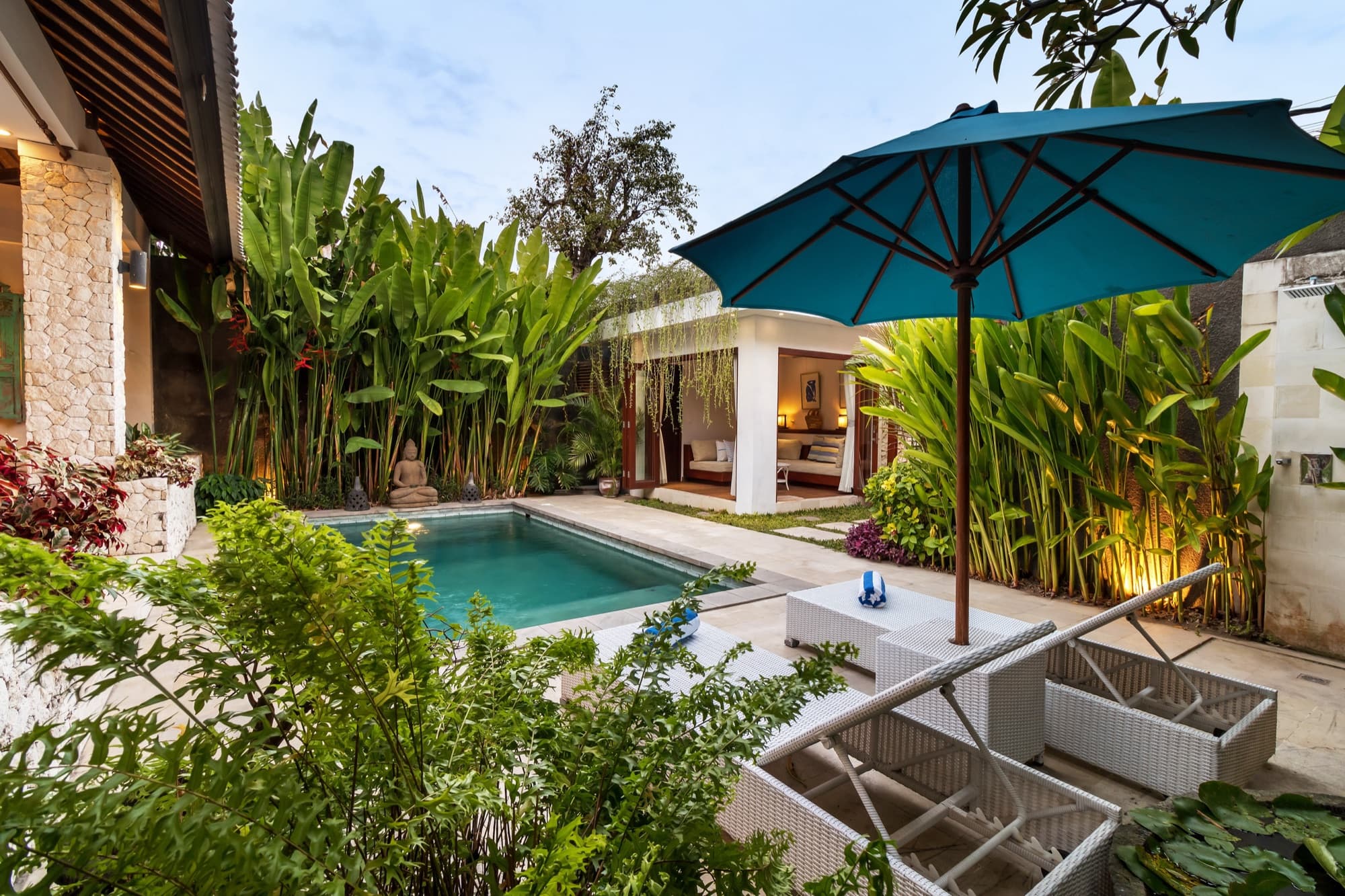 Villa Blue Bali — tropical garden with pool, daybed and bird-of-paradise planting