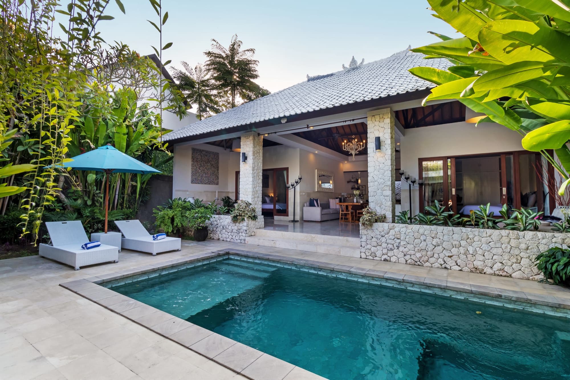 Villa Blue Bali — private pool in daylight with sun loungers and turquoise umbrella