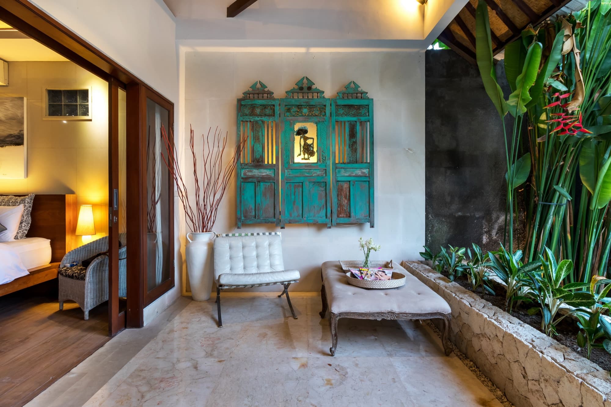 Villa Blue Bali — courtyard terrace with antique Balinese doors and lush planting